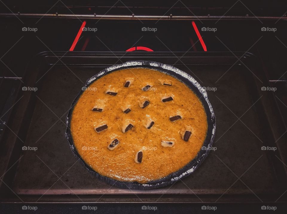 Pumpkin pie with chocolate chunks coming out of the oven 