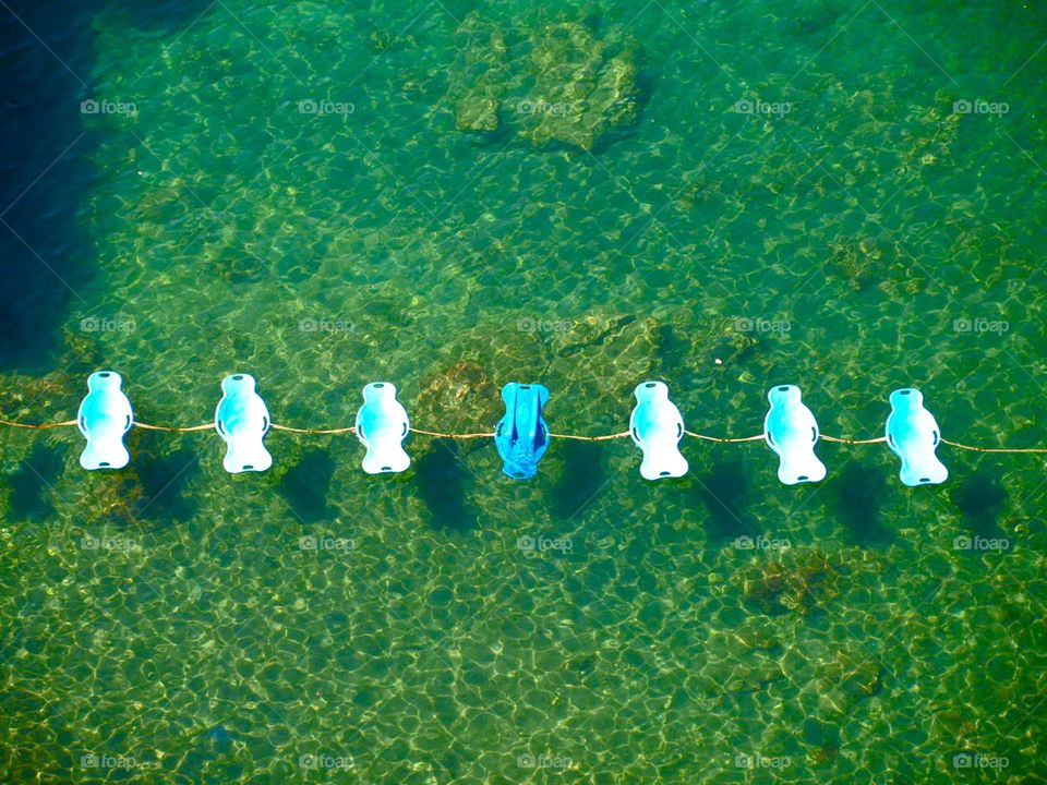 pedal boats in a row to the sea