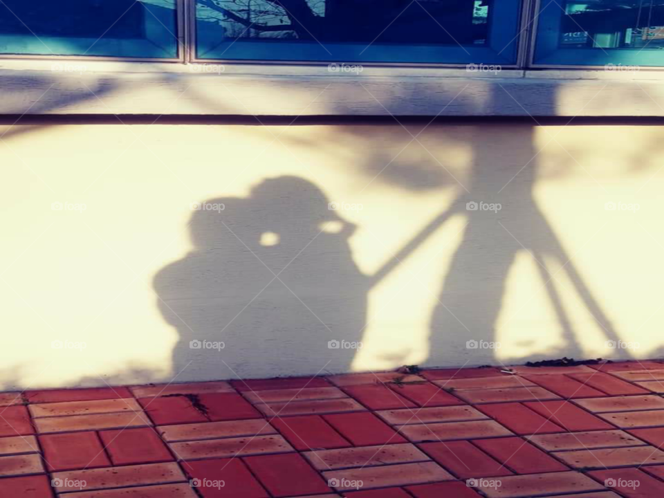 an shadow of a child who's kissing her mother  forehead.