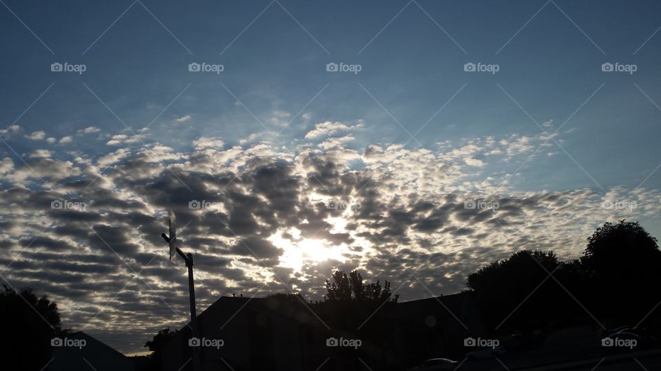Clouds below blue sky