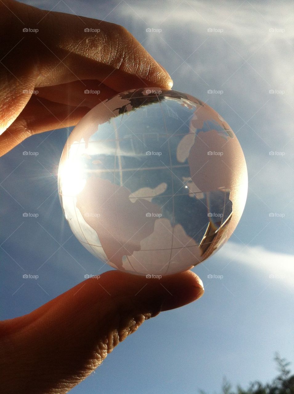 Close-up of person's hand holding glass globe