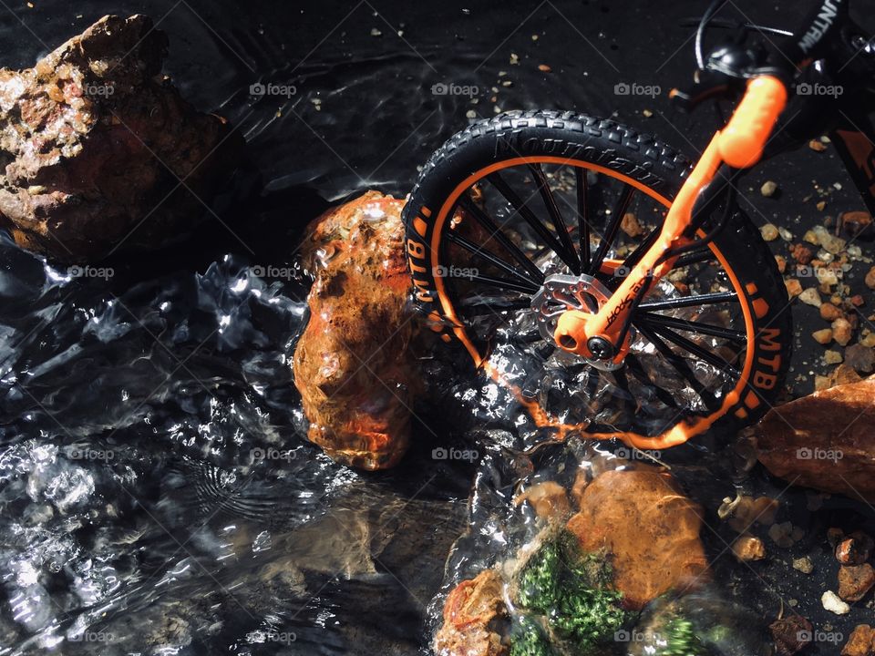 downhill mountain bike crossing river 