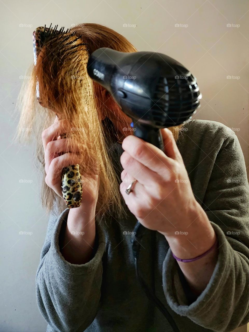 Blow drying my hair.