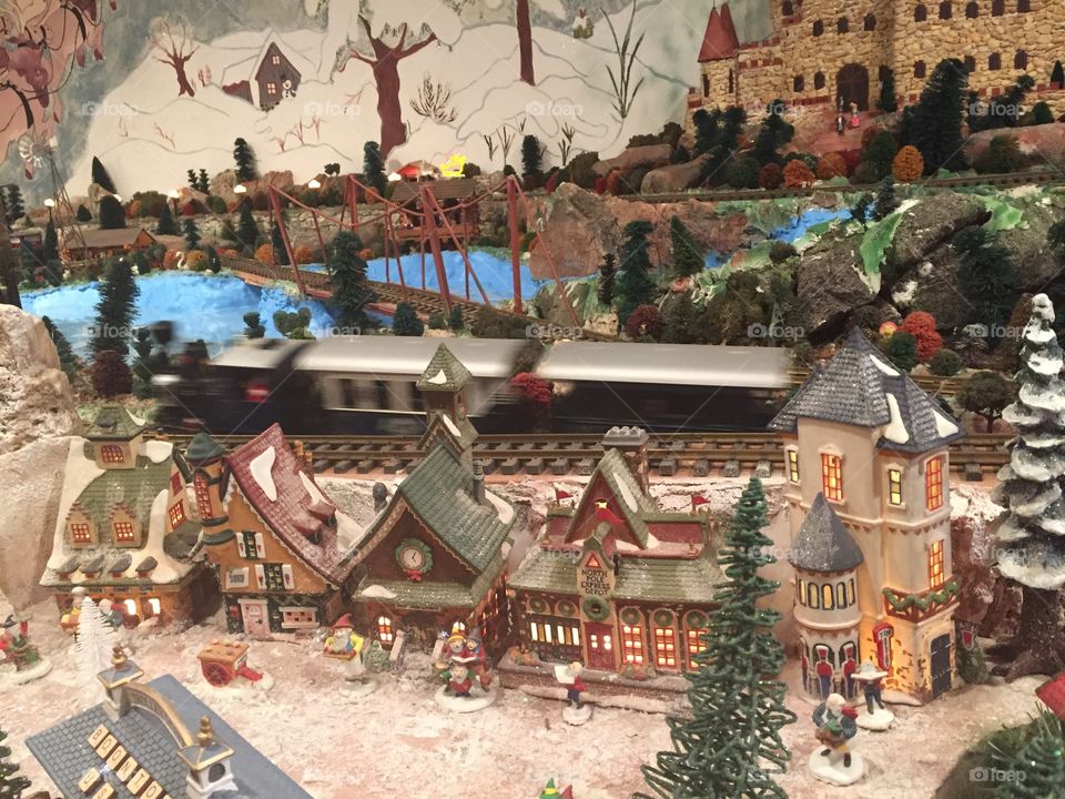 Train moving through Christmas village. 