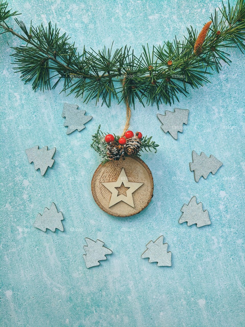 Christmas or New Year composition.  Fir branches with festive decor on a light blue background. Top view. Flat lay.