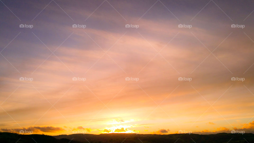 Dreamy pink skies over some hills