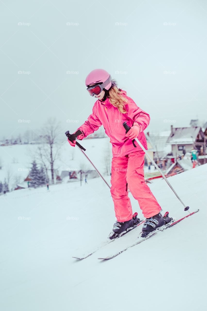 Girl skiing down the slope