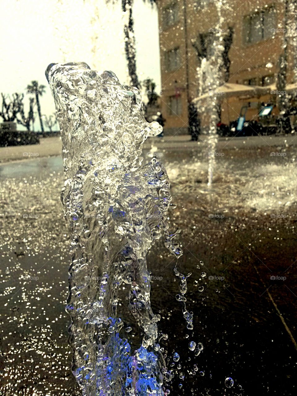 water in motion: Close up of water splash from a fountain with colored light