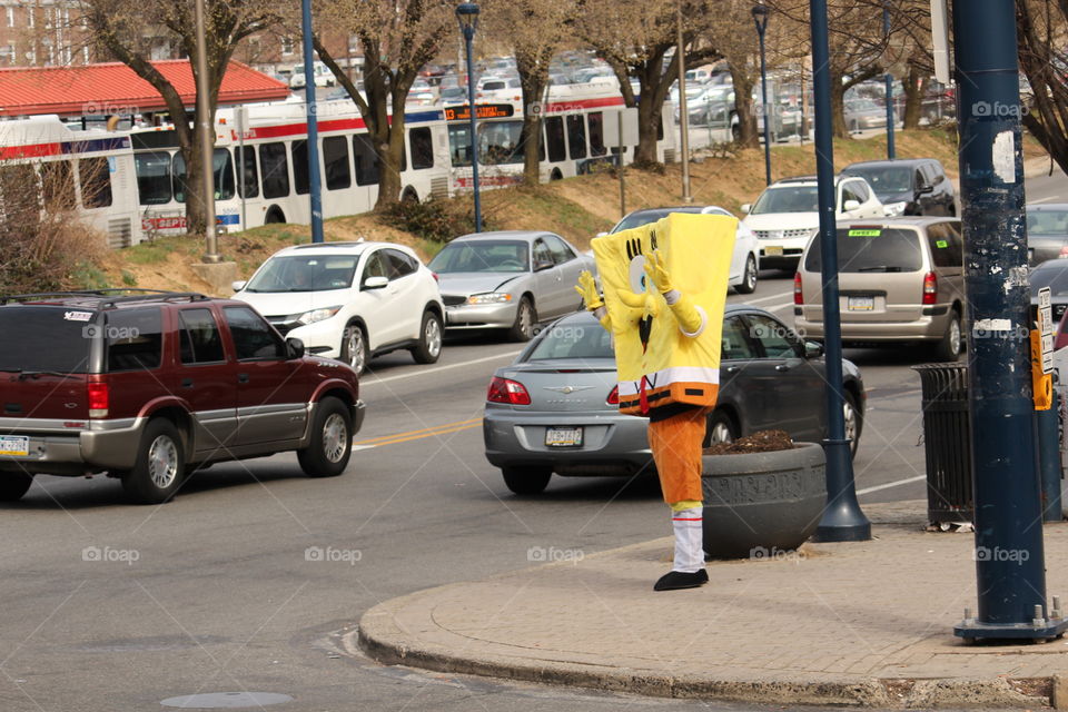 Spongebob waving to cars and buses