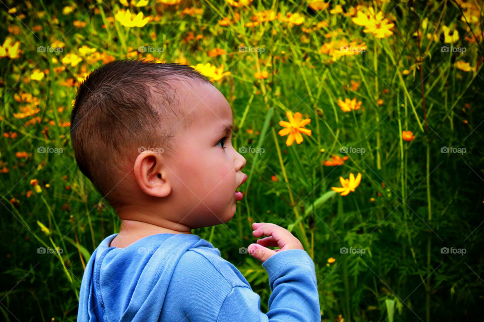 When spring comes.... Thitiwin stand in front of blooming flower