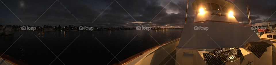 I took this panorama waiting to sail off on a deep sea fishing trip off the coast of Long Beach, California. I saw the dark, clouds against the peaceful sunset and had to capture the moment. 