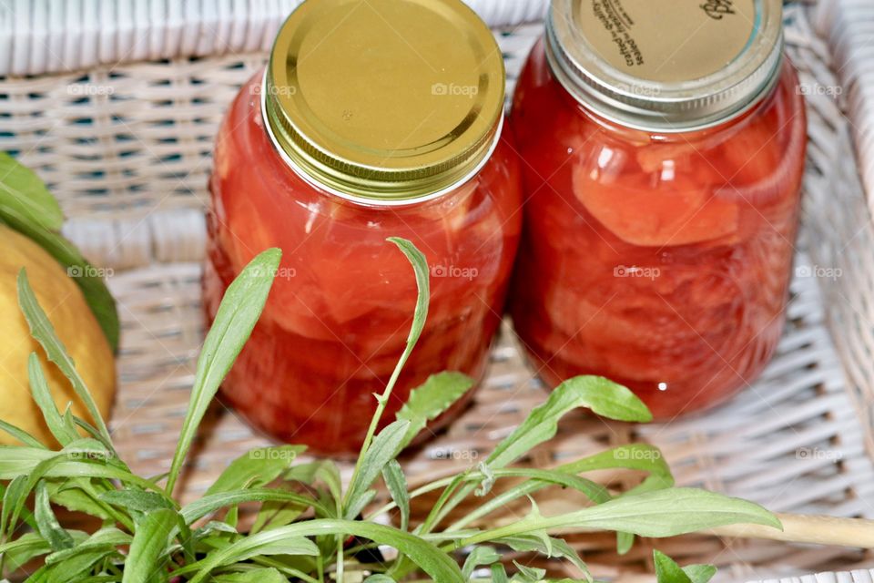 Putting up fruit for the winter in quart sized canning jars; quince fruit preserves 