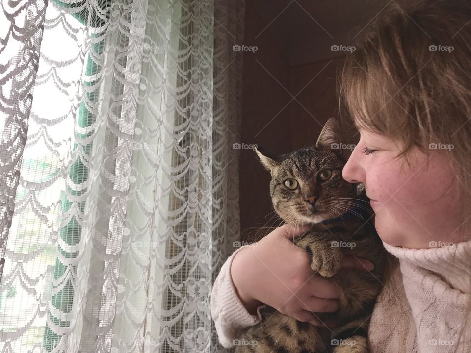 A girl and a gray cat.