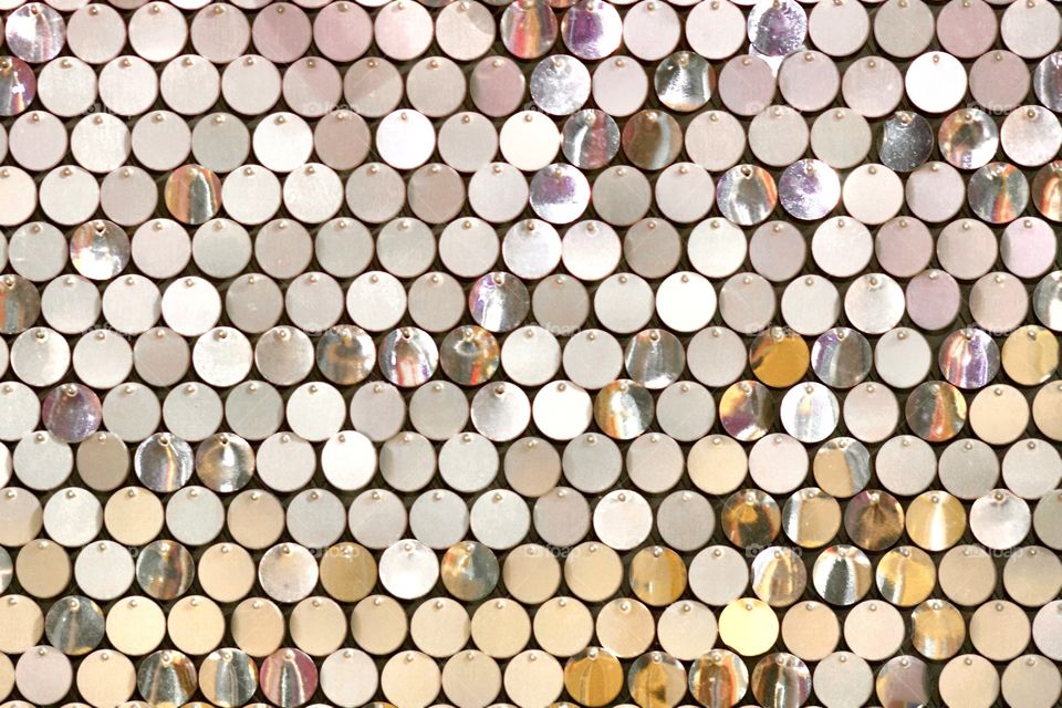 Glittering metal discs background in gold and silver with reflections 