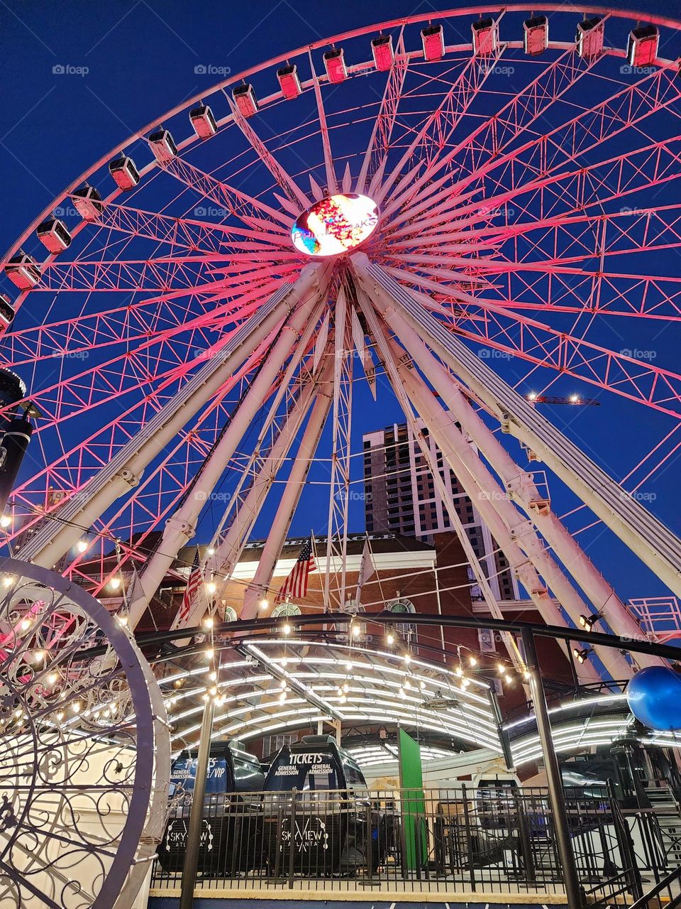 A large brightly lit Ferris Wheel adds a vibrant touch to downtown Atlanta Georgia
