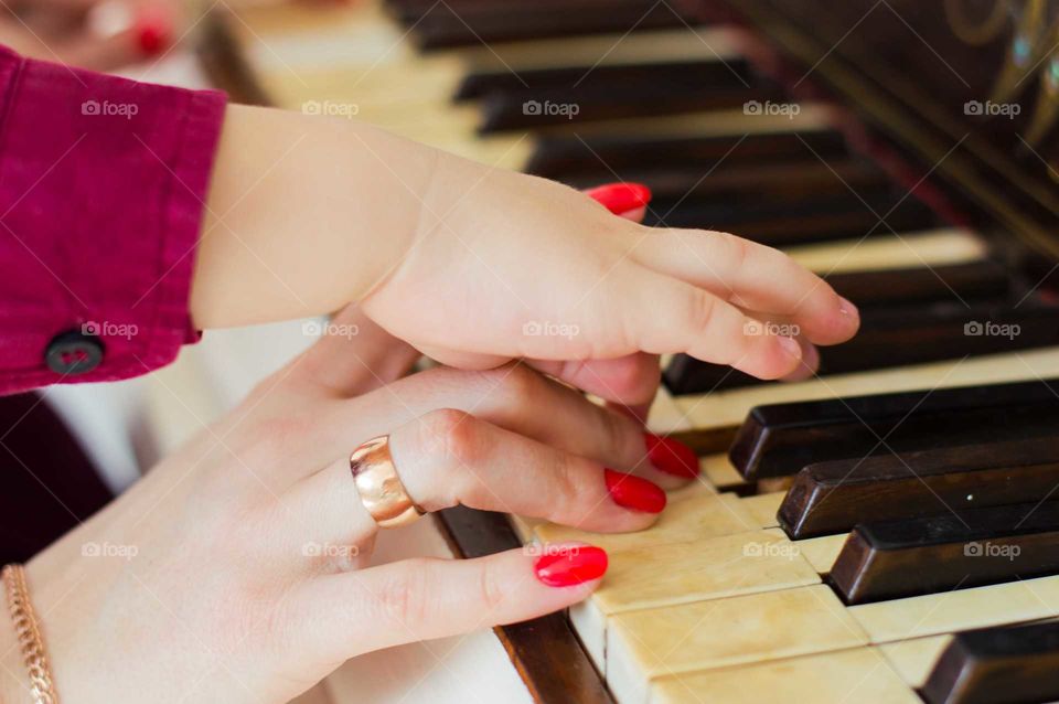 mother teach a son to play piano