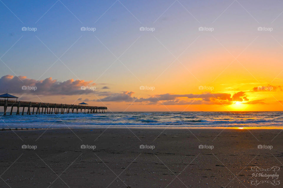 sunrise beside pier