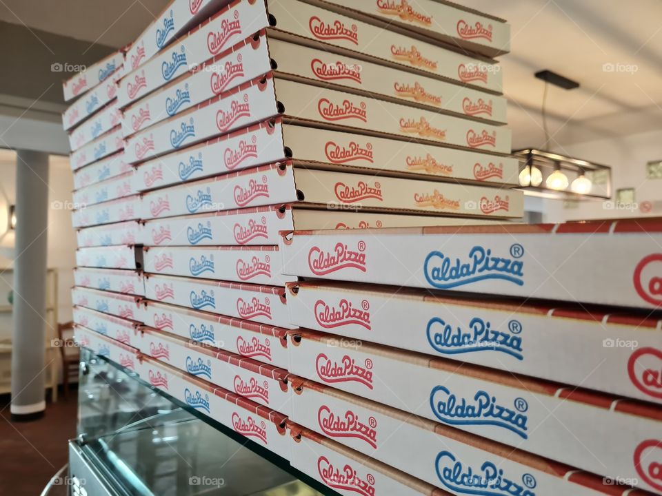 stacked cardboard pizza boxes