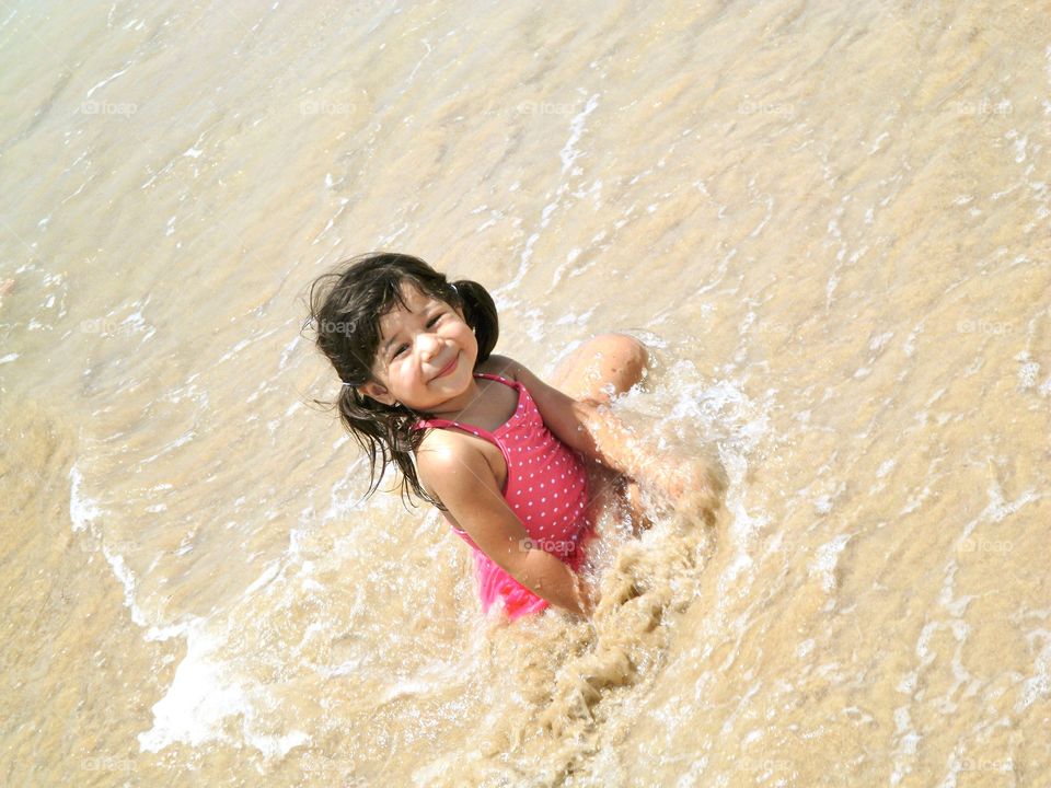Girl playing in the water having fun 