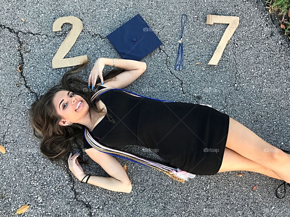 High angle view of woman lying on road