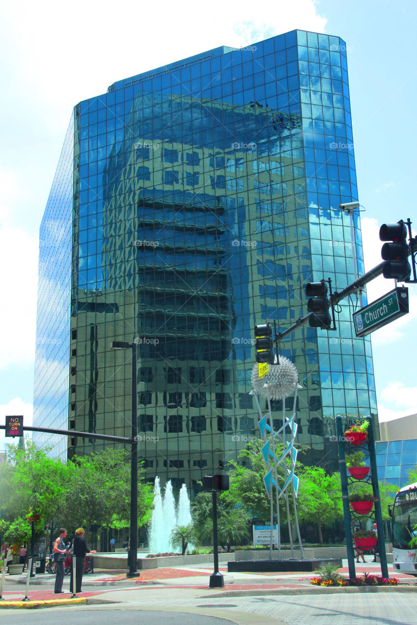 Full reflection of a building within a building. Here's one of the coolest shots I have ever taken the full reflection of another building captured in a glass moder skyscraper in downtown Orlando
