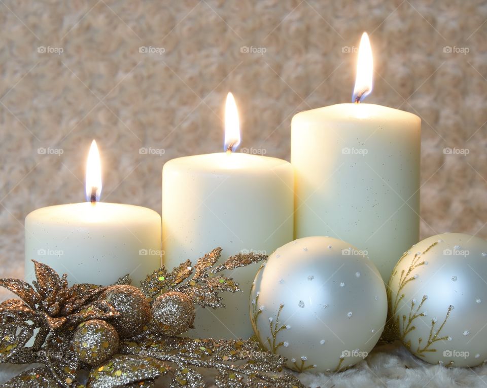 Christmas candles ivory and gold with flame