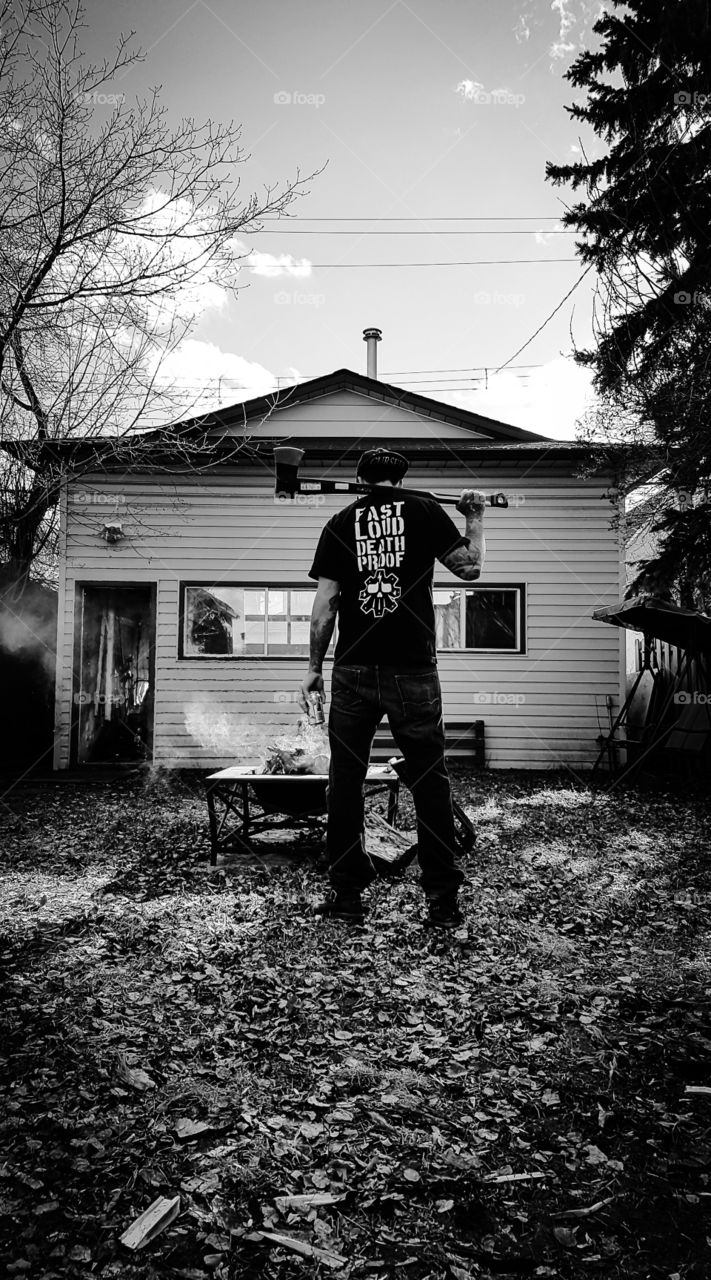 around the fire with a beer and an axe