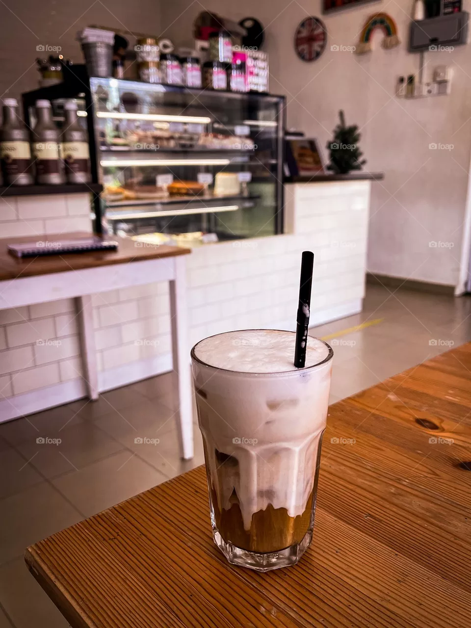 Caffe latte in a coffee shop. Interior of white and brown color