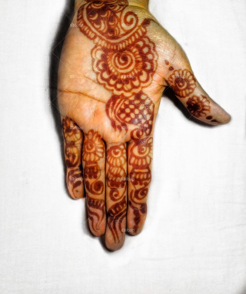 I see a hand that belongs to a woman who can tackle not only the archaic traditions and stereotypes but also is capable of achieving her own ambitions. 
Let mehendi not be a prison tattoo but  a mark of freedom.