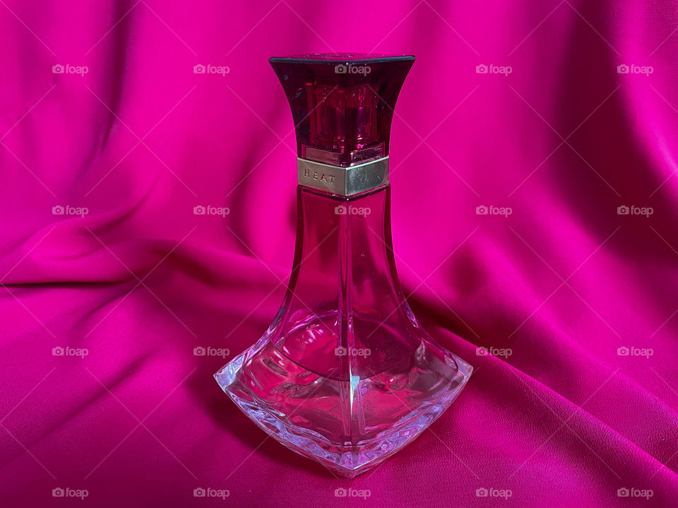 Perfume bottle and pink background.