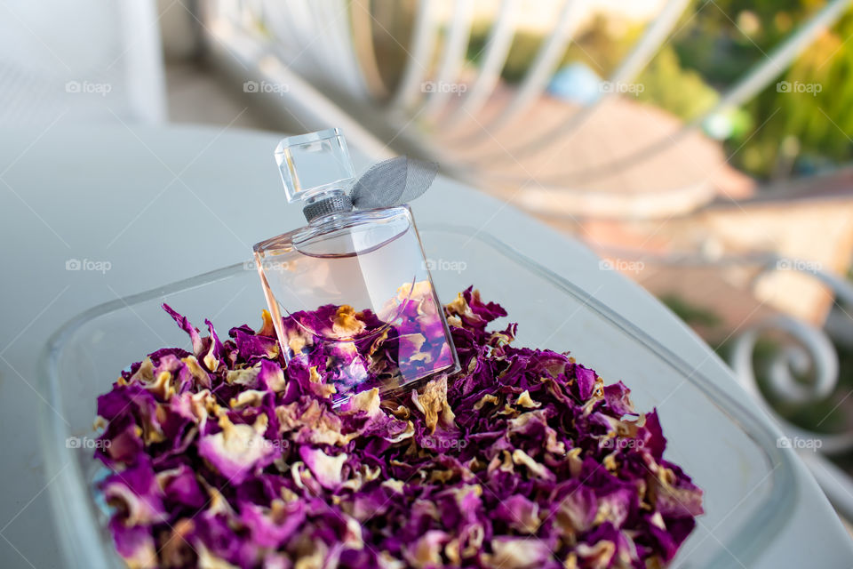 simple tiny perfume on a bed of dried flower petals