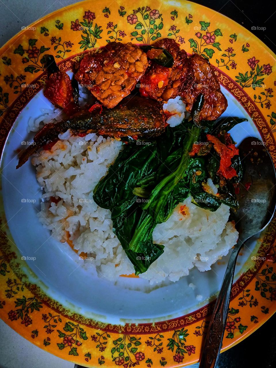 Fried fish and rice, Indonesian traditional home cooking. Local food. Flat lay top down overhead view