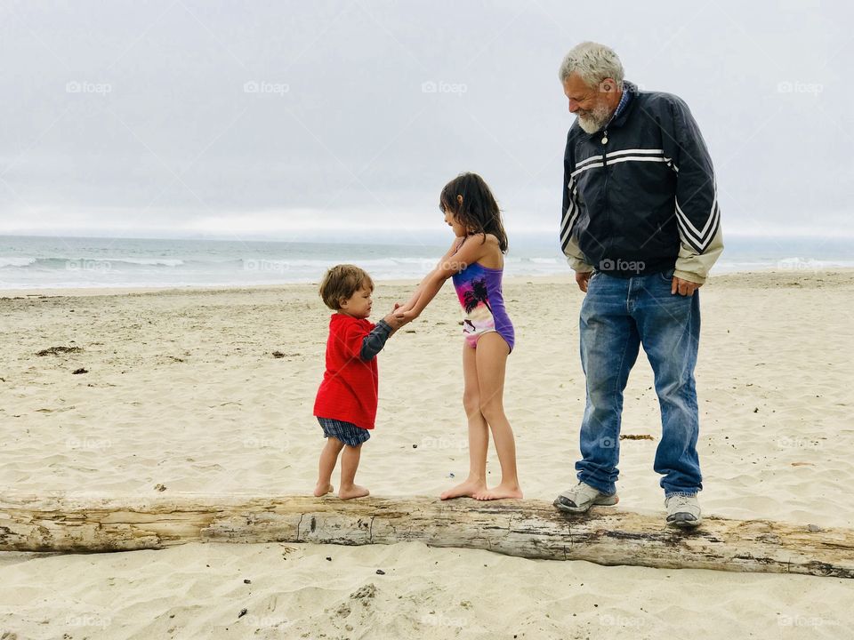 Awesome memories! On a log with grandpa at the beach