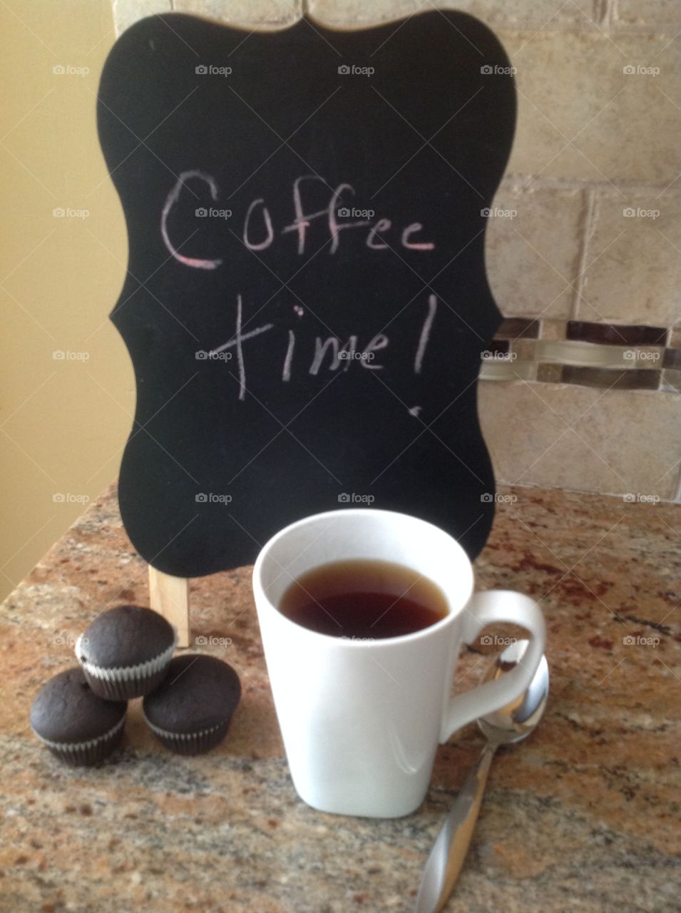 It's coffee time! Enjoying a cup of coffee with mini cupcakes.