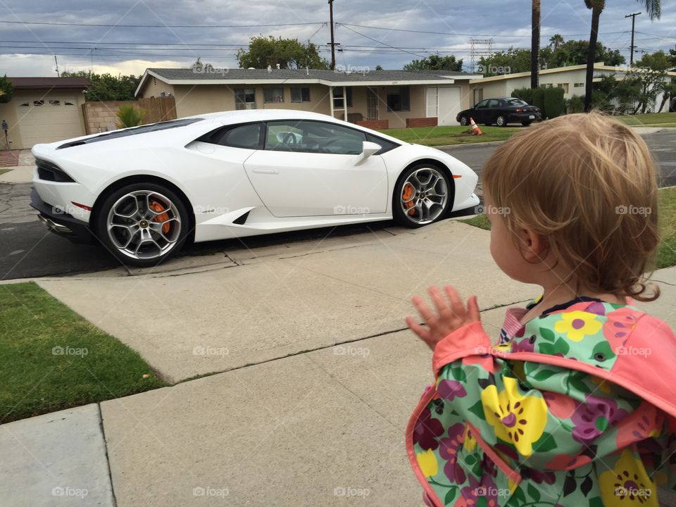 Lamborghini girl . Lambo in front of our house. Zoey waiving. 