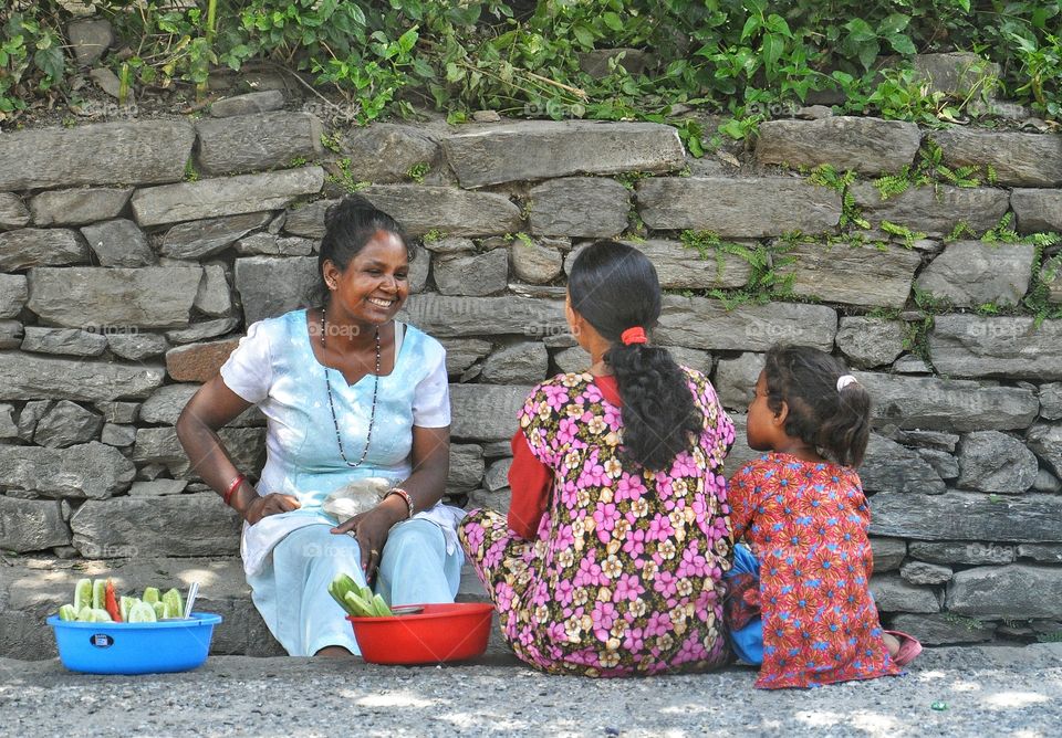 nepalese women selling cucumbers in the street of kathmandu in nepal